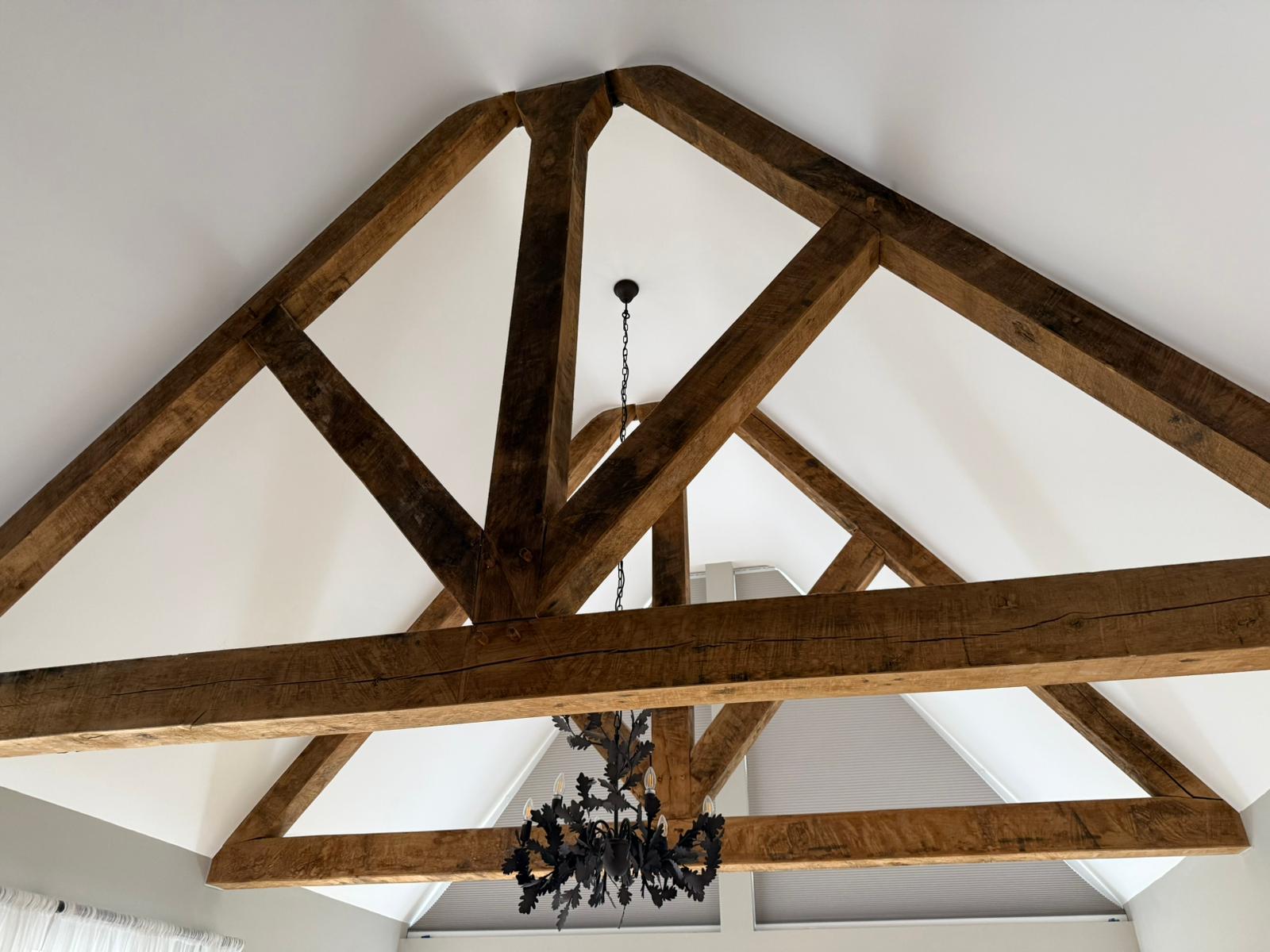 Attic room with chandelier and dark feature wall