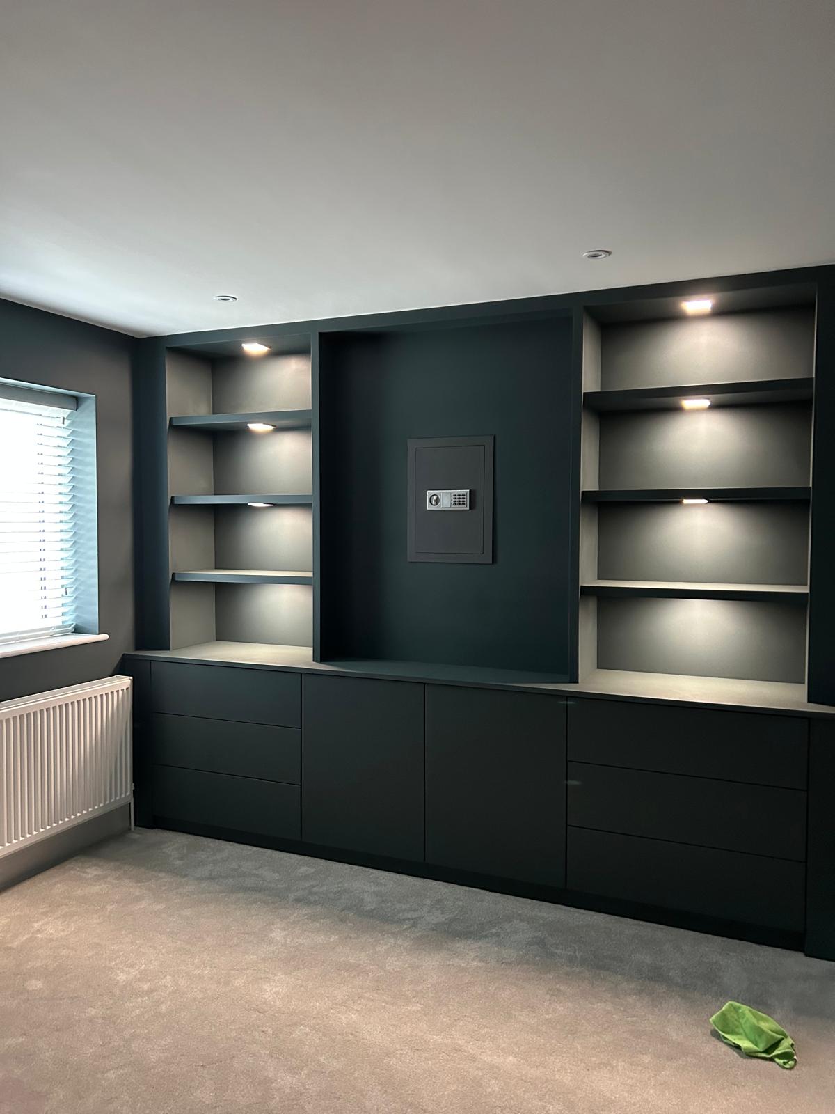 After — fitted shelving painted dark teal with lighting
